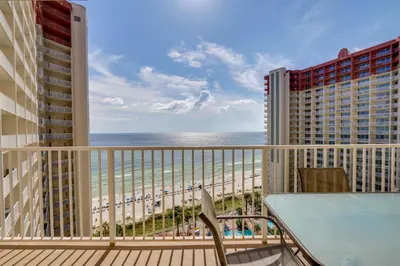 a balcony with a table and a view of the beach at Shores of Panama #1421 by Book That Condo in Panama City Beach