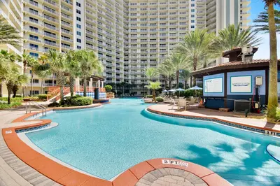 a swimming pool at a resort with a large building at Shores of Panama #1531 by Book That Condo in Panama City Beach