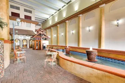 a pool in the middle of a building with chairs at Shores of Panama #1531 by Book That Condo in Panama City Beach