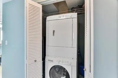 a laundry room with a washer and a washing machine at Shores of Panama #2201 by Book That Condo in Panama City Beach