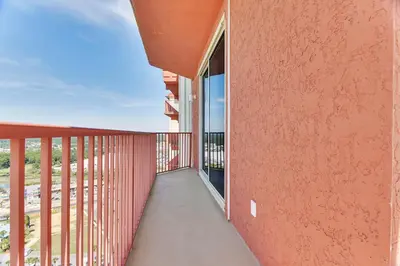 a balcony of a building with a red wall at Shores of Panama #2201 by Book That Condo in Panama City Beach