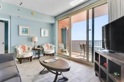 a living room with a couch and a television at Shores of Panama #2201 by Book That Condo in Panama City Beach