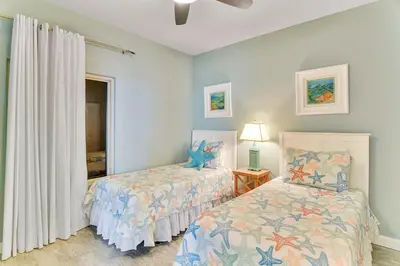 a bedroom with two beds and a window at Shores of Panama #2201 by Book That Condo in Panama City Beach