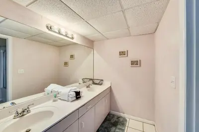 a bathroom with two sinks and a mirror at Long Beach Resort #1300-1 by Book That Condo in Panama City Beach