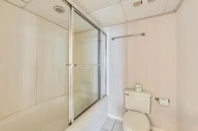 a bathroom with a shower and a toilet at Long Beach Resort #1300-1 by Book That Condo in Panama City Beach