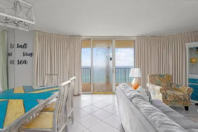 a bedroom with a bed and a couch in a room at Long Beach Resort #1300-1 by Book That Condo in Panama City Beach