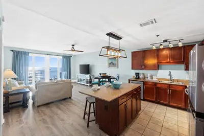 a kitchen and living room with a couch and a table at Laketown Wharf Resort #1321 by Book That Condo in Panama City Beach