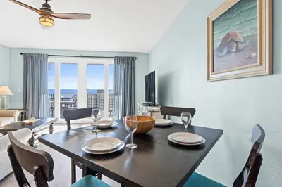 a dining room with a table and a room with a view at Laketown Wharf Resort #1321 by Book That Condo in Panama City Beach