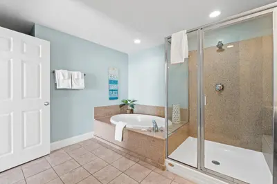 a bathroom with a tub and a glass shower at Laketown Wharf Resort #1321 by Book That Condo in Panama City Beach