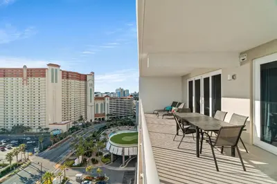 a balcony with a table and chairs and a view of a city at Laketown Wharf Resort #1321 by Book That Condo in Panama City Beach