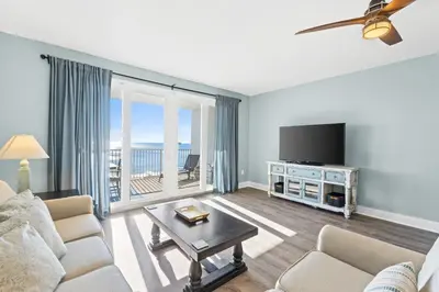 a living room with a couch and a tv at Laketown Wharf Resort #1321 by Book That Condo in Panama City Beach