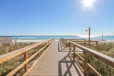 a wooden boardwalk leading to the beach at Majestic Beach Resort #1502-1 by Book That Condo in Panama City Beach