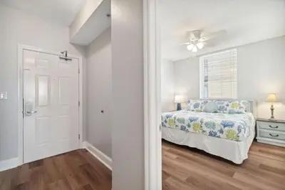 a bedroom with a bed and a ceiling fan at Majestic Beach Resort #1215-1 by Book That Condo in Panama City Beach