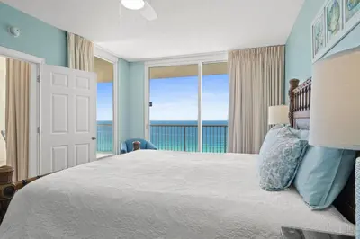 a bedroom with a bed with a view of the ocean at Majestic Beach Resort #1309-2 by Book That Condo in Panama City Beach