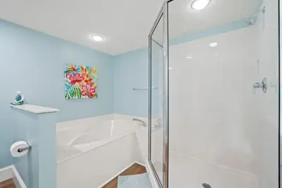 a bathroom with a shower and a white tub at Majestic Beach Resort #1309-2 by Book That Condo in Panama City Beach
