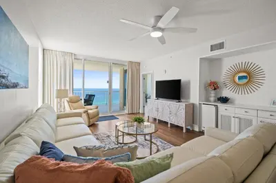 a living room with a couch and a tv at Majestic Beach Resort #1309-2 by Book That Condo in Panama City Beach