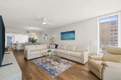 a living room with two white couches and a table at Majestic Beach Resort #1309-2 by Book That Condo in Panama City Beach