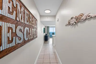 a hallway with a sign that reads the beach house at Majestic Beach Resort #1307-1 by Book That Condo in Panama City Beach