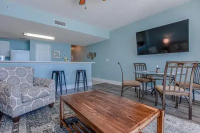 a living room with a couch and a table at Majestic Beach Resort #1613-1 by Book That Condo in Panama City Beach