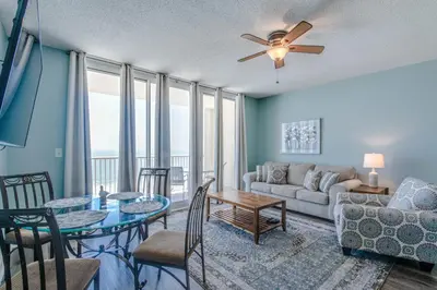 a living room with a couch and a table at Majestic Beach Resort #1613-1 by Book That Condo in Panama City Beach