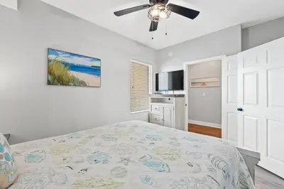 a bedroom with a bed and a ceiling fan at Tidewater Beach Resort #614 by Book That Condo in Panama City Beach