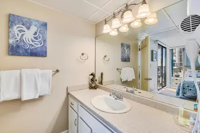 a bathroom with a sink and a mirror at Aquavista Condominiums #206-W by Book That Condo in Panama City Beach