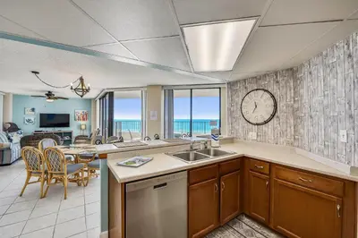 a kitchen and dining room with a view of the ocean at Aquavista Condominiums #206-W by Book That Condo in Panama City Beach
