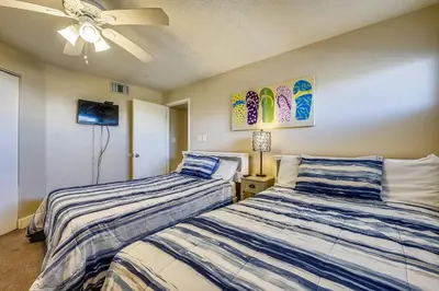 a bedroom with two beds and a ceiling fan at Aquavista Condominiums #206-W by Book That Condo in Panama City Beach