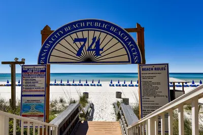 a sign for the beach at the beach nourishment publicconservancy at Splash Beach Resort #1503-E by Book That Condo in Panama City Beach