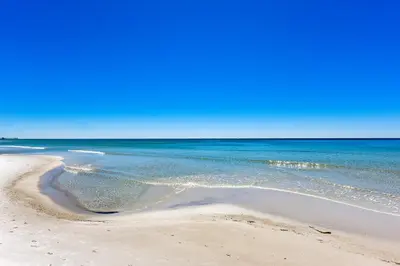 a sandy beach with the ocean in the background at Splash Beach Resort #1503-E by Book That Condo in Panama City Beach
