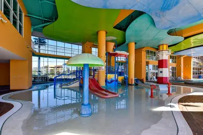 a water park with a slide in a building at Splash Beach Resort #1503-E by Book That Condo in Panama City Beach