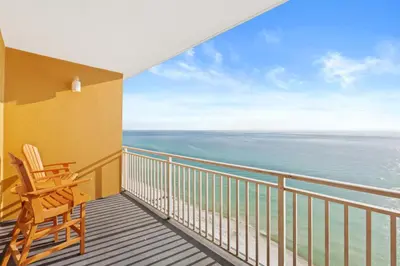 a balcony with two chairs and the ocean at Splash Beach Resort #1503-E by Book That Condo in Panama City Beach
