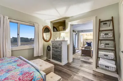 a bedroom with a bed and a mirror at Pinnacle Port #115A by Book That Condo in Panama City Beach