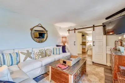 a living room with a white couch and a table at Pinnacle Port #115A by Book That Condo in Panama City Beach