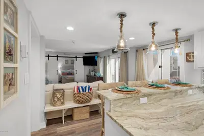 a kitchen and living room with a large counter top at Pinnacle Port #115A by Book That Condo in Panama City Beach