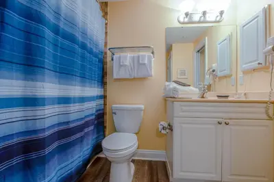 a bathroom with a toilet and a sink at Boardwalk Beach Resort #604 by Book That Condo in Panama City Beach