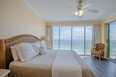 a bedroom with a bed with a view of the ocean at Boardwalk Beach Resort #604 by Book That Condo in Panama City Beach