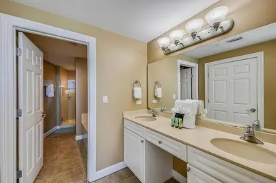 a bathroom with two sinks and a large mirror at Boardwalk Beach Resort #803 by Book That Condo in Panama City Beach