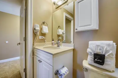 a bathroom with a sink and a toilet and a mirror at Boardwalk Beach Resort #803 by Book That Condo in Panama City Beach