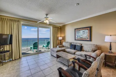 a living room with a couch and a view of the ocean at Boardwalk Beach Resort #803 by Book That Condo in Panama City Beach