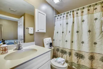 a bathroom with a sink and a shower curtain at Boardwalk Beach Resort #803 by Book That Condo in Panama City Beach