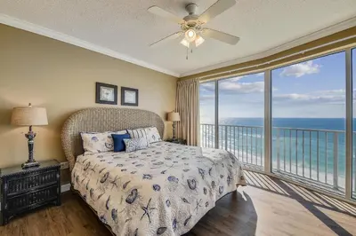 a bedroom with a bed with a view of the ocean at Boardwalk Beach Resort #803 by Book That Condo in Panama City Beach