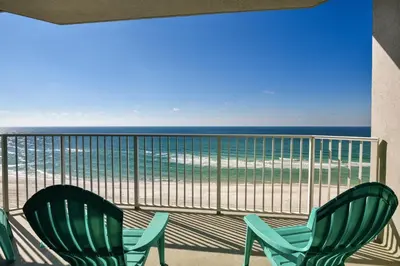 two green chairs on a balcony with the beach at Boardwalk Beach Resort #803 by Book That Condo in Panama City Beach