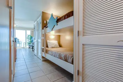 a bedroom with a bunk bed in a house at Boardwalk Beach Resort #806 by Book That Condo in Panama City Beach
