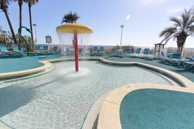 a swimming pool with a fountain in the middle at Boardwalk Beach Resort #806 by Book That Condo in Panama City Beach