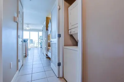 a hallway with white cabinets and a tile floor at Boardwalk Beach Resort #806 by Book That Condo in Panama City Beach