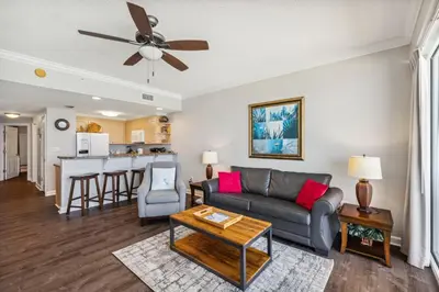 a living room with a couch and a table at Boardwalk Beach Resort #806 by Book That Condo in Panama City Beach