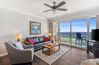 a living room with a couch and a large window at Boardwalk Beach Resort #806 by Book That Condo in Panama City Beach