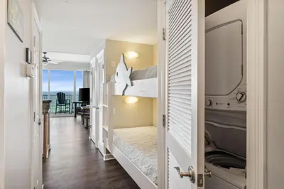 a small room with a bed and a balcony at Boardwalk Beach Resort #806 by Book That Condo in Panama City Beach