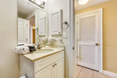 a bathroom with a sink and a mirror at Boardwalk Beach Resort #1605 by Book That Condo in Panama City Beach